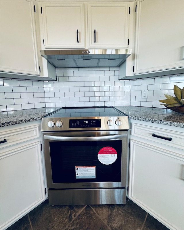 kitchen with light stone counters, stainless steel range with electric cooktop, ventilation hood, and white cabinetry