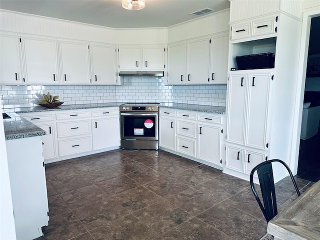 kitchen with stainless steel range with electric stovetop, under cabinet range hood, white cabinets, and decorative backsplash