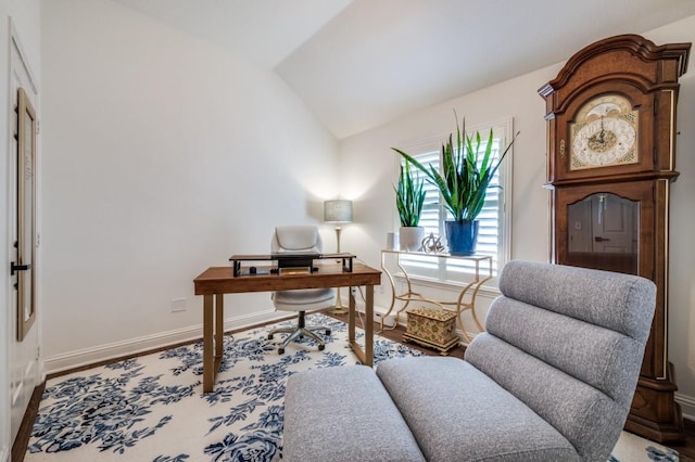 office with baseboards, vaulted ceiling, and wood finished floors