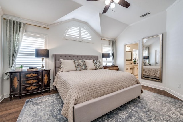 bedroom with multiple windows, visible vents, vaulted ceiling, and wood finished floors