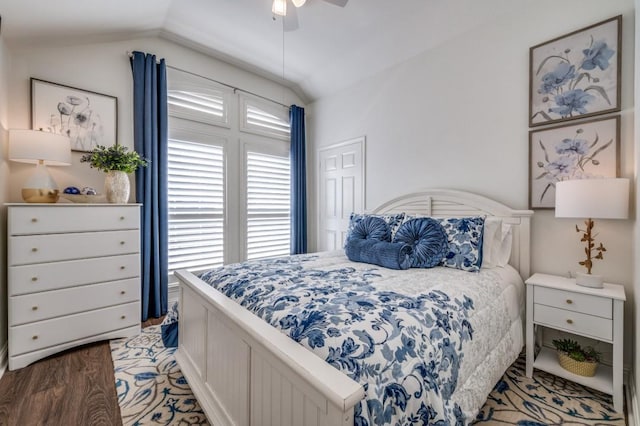 bedroom featuring a ceiling fan, vaulted ceiling, and wood finished floors