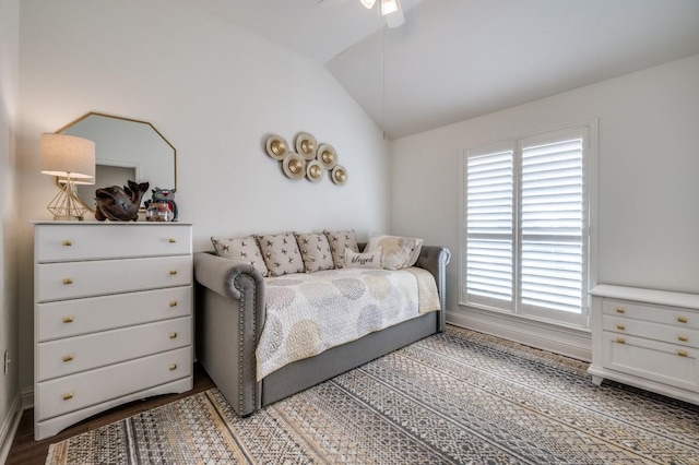 bedroom with a ceiling fan, lofted ceiling, and wood finished floors