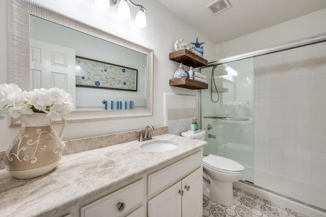 full bath with toilet, a stall shower, visible vents, and vanity