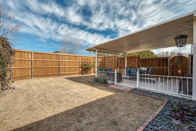 view of yard featuring fence and a patio