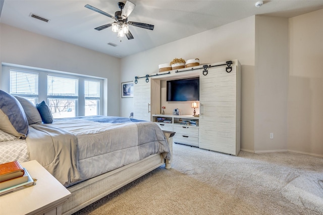 bedroom featuring ceiling fan, baseboards, visible vents, and light carpet