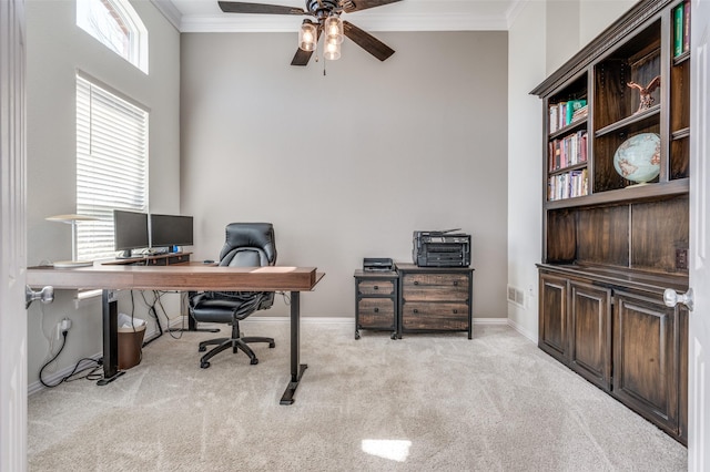 carpeted office featuring visible vents, a ceiling fan, crown molding, and baseboards