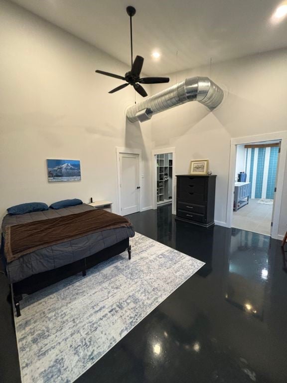 bedroom featuring ceiling fan and a high ceiling