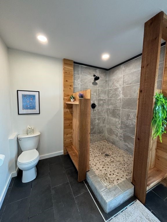 bathroom featuring toilet, recessed lighting, baseboards, tile patterned floors, and walk in shower