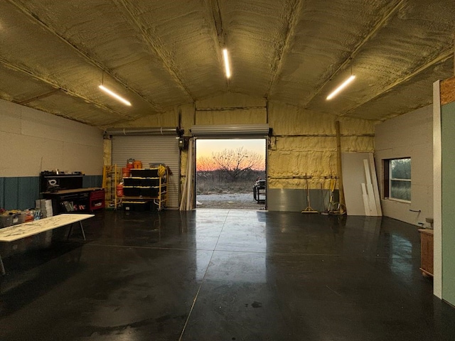 view of garage at dusk