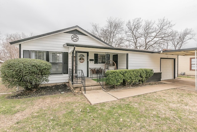 view of front of home featuring a garage, a porch, and a front yard