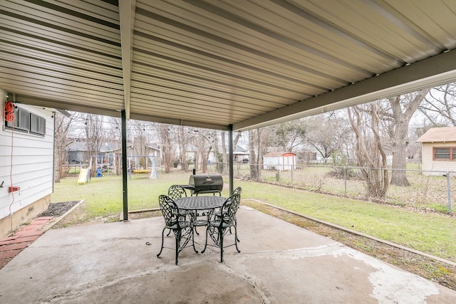 view of patio / terrace with outdoor dining area, a playground, a grill, a residential view, and a fenced backyard