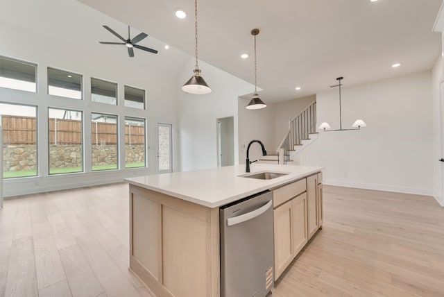 3206 Bexar St, Rockwall, TX 75032 - kitchen featuring dishwasher, ceiling fan, light wood-style flooring, open floor plan, and light countertops