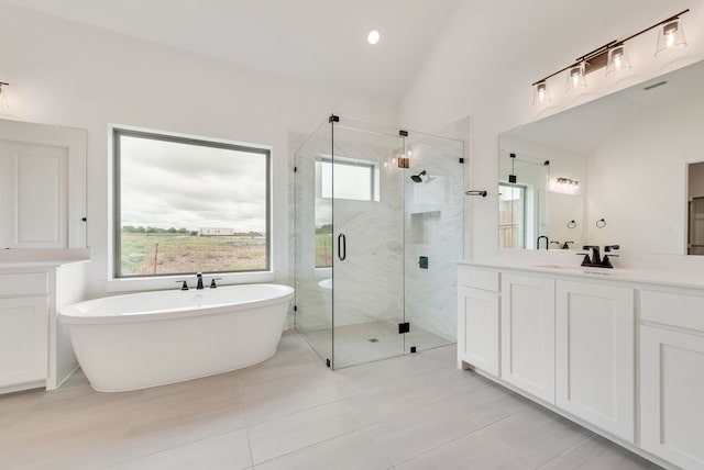 3206 Bexar St, Rockwall, TX 75032 - full bathroom with vanity, a soaking tub, vaulted ceiling, a stall shower, and healthy amount of natural light