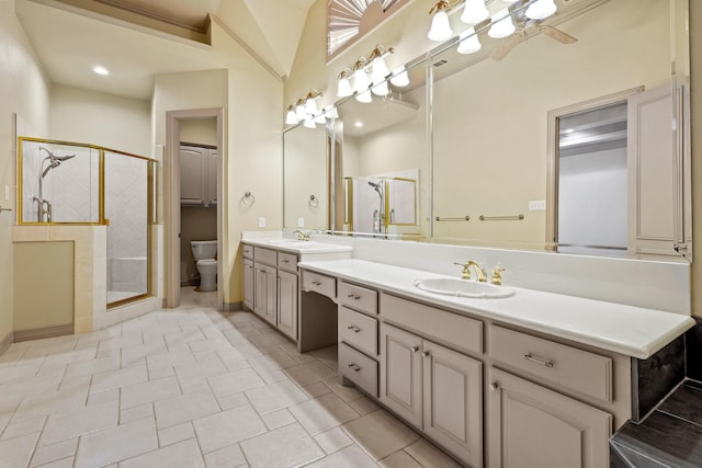 full bath featuring a sink, a shower stall, and toilet