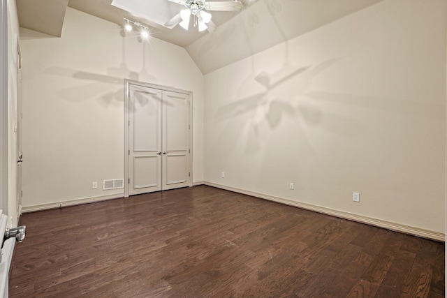 unfurnished bedroom with lofted ceiling, ceiling fan, dark wood-style flooring, and visible vents