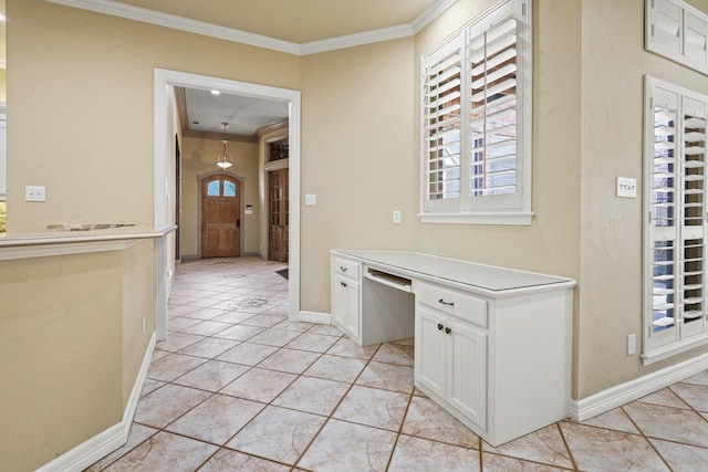 interior space featuring baseboards, ornamental molding, and a healthy amount of sunlight