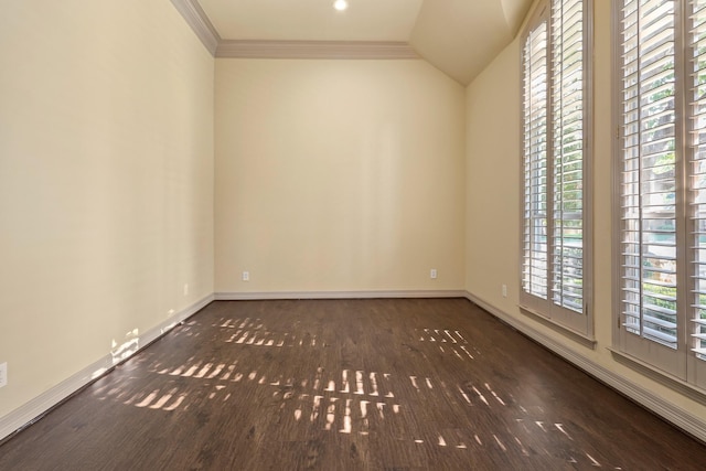 unfurnished room featuring dark wood-type flooring, vaulted ceiling, crown molding, and baseboards