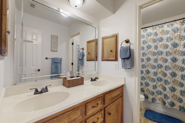1001 British Blvd, Grand Prairie, TX 75050 - bathroom with a sink, visible vents, toilet, and double vanity