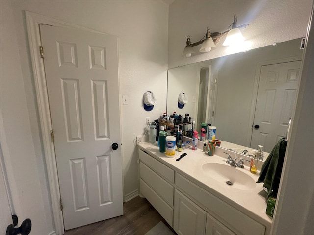 1520 Bagby Ave, Waco, TX 76706 - bathroom with vanity and wood finished floors