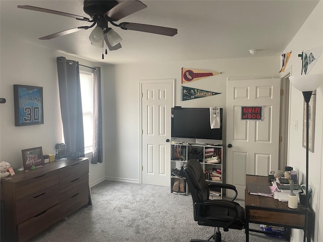 office featuring a ceiling fan, carpet, and baseboards