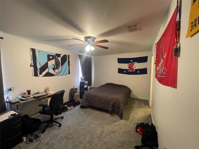 carpeted bedroom with a ceiling fan, visible vents, and a textured ceiling