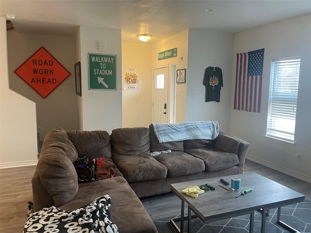 living area with wood finished floors and baseboards