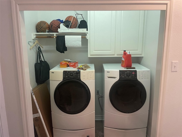 laundry area featuring independent washer and dryer and cabinet space