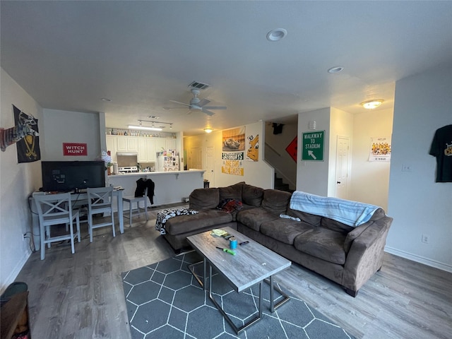 1520 Bagby Ave, Waco, TX 76706 - living area with wood finished floors, stairs, baseboards, and a ceiling fan