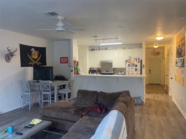 1520 Bagby Ave, Waco, TX 76706 - living area featuring wood finished floors, ceiling fan, and baseboards