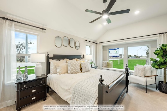 bedroom featuring lofted ceiling, multiple windows, ceiling fan, and light carpet