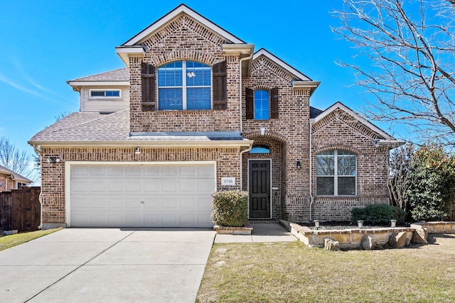 view of front of property with a shingled roof, a front lawn, concrete driveway, and brick siding