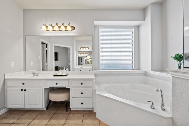 full bath featuring double vanity, a sink, a bath, and tile patterned floors