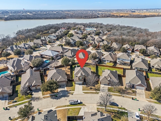 drone / aerial view featuring a residential view and a water view