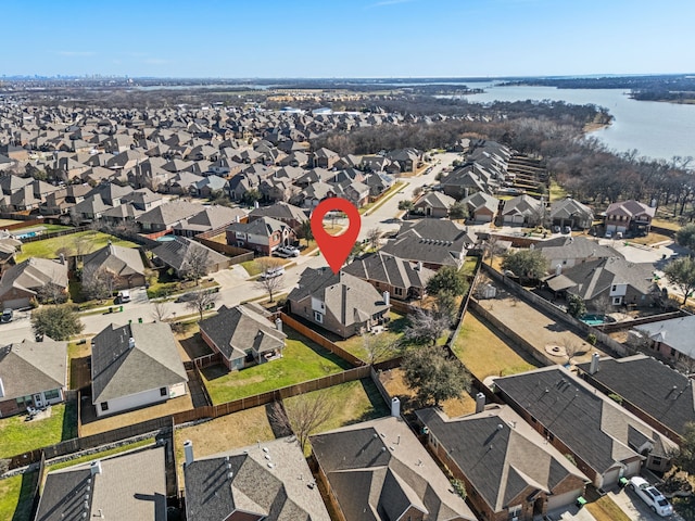 drone / aerial view featuring a water view and a residential view