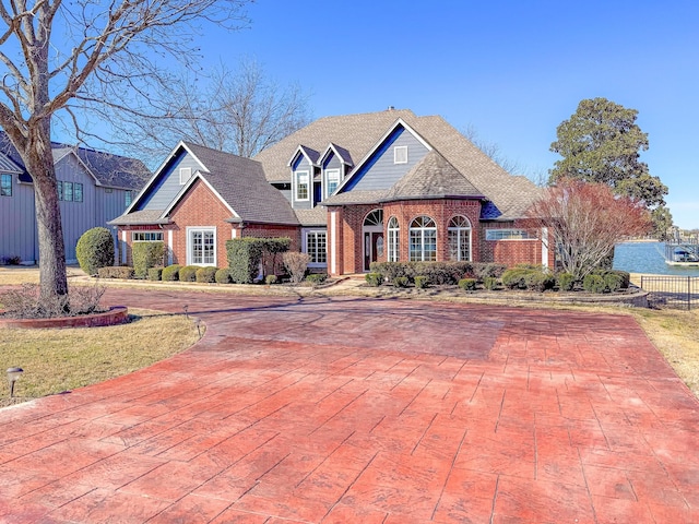 view of front of property with driveway and brick siding