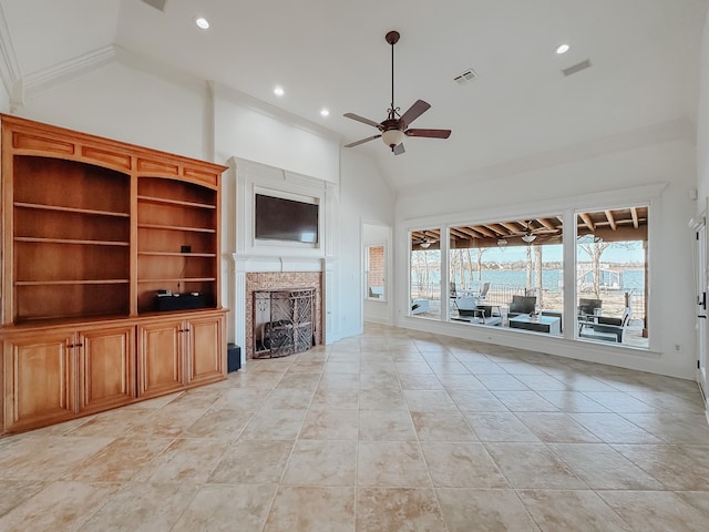 unfurnished living room with tile patterned flooring, a stone fireplace, visible vents, a ceiling fan, and ornamental molding