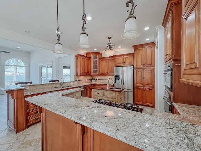 kitchen with decorative backsplash, stainless steel appliances, visible vents, and a sink