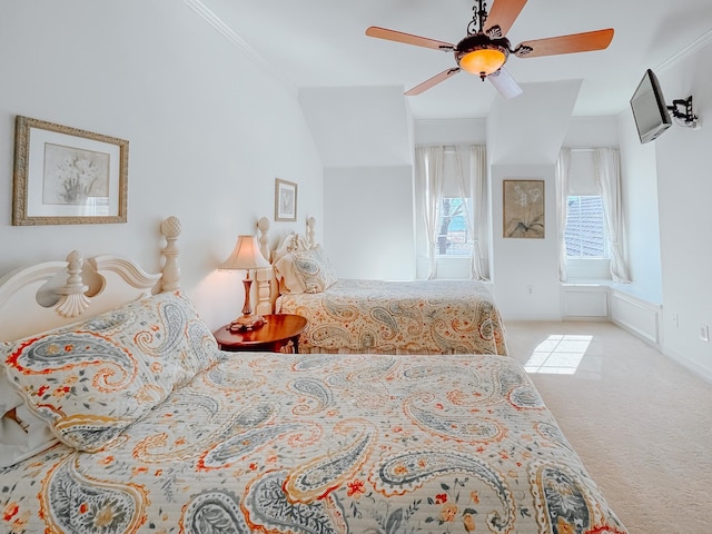 bedroom featuring crown molding, ceiling fan, and light colored carpet