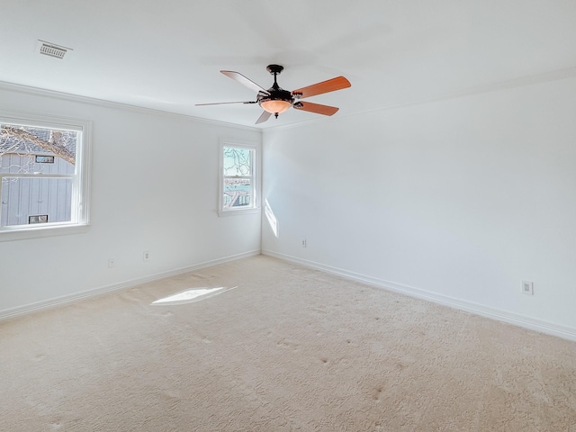 spare room with baseboards, visible vents, ceiling fan, and carpet flooring