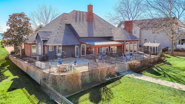 back of property featuring a patio, a chimney, an outdoor structure, and fence