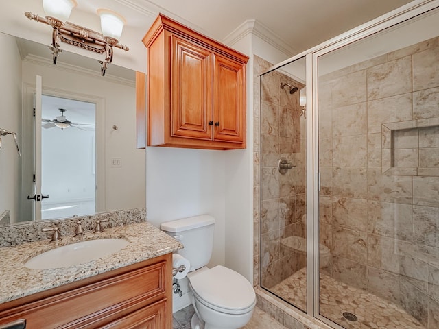 bathroom featuring vanity, a shower stall, toilet, and crown molding