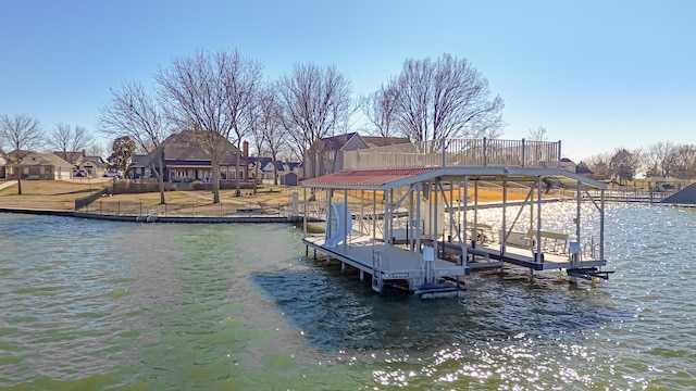 view of dock with a water view, boat lift, and a residential view