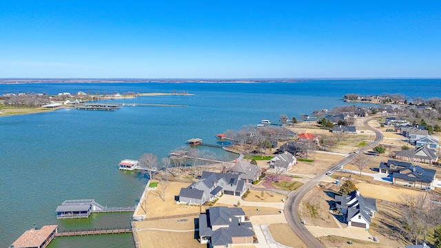 drone / aerial view with a residential view and a water view