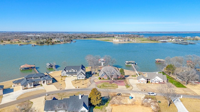 drone / aerial view with a water view and a residential view