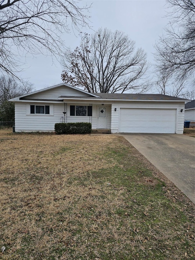 ranch-style home with a garage, driveway, and a front lawn