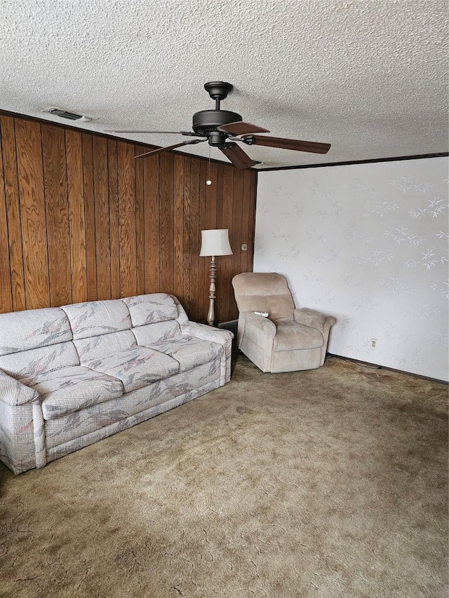 unfurnished living room with a ceiling fan, a textured ceiling, visible vents, and carpet flooring