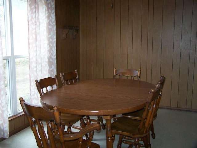 dining space featuring wooden walls