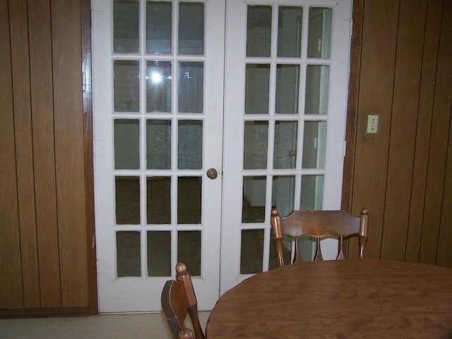 entryway with french doors and wood walls