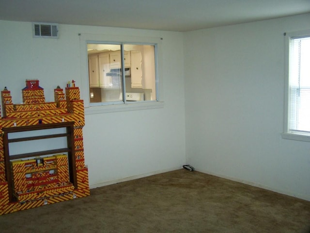 interior space featuring visible vents and dark colored carpet