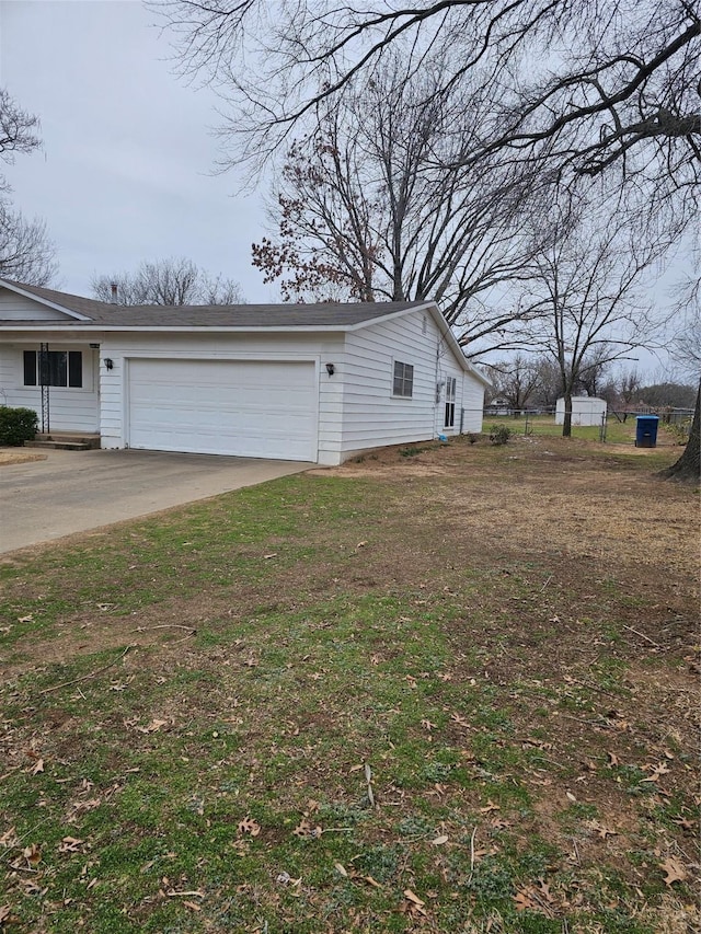 exterior space featuring concrete driveway and an attached garage